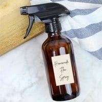 An amber spray bottle of homemade flea spray.
