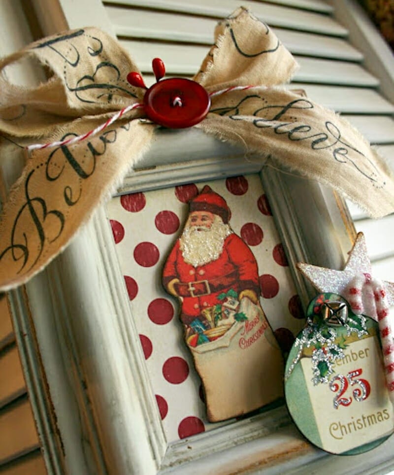 A picture frame filled and decorated with pieces of old christmas cards.