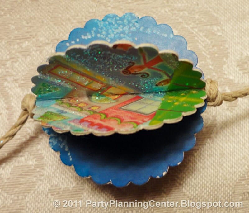 A sparkly ornament made from old christmas cards.