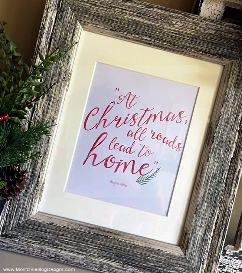 A Christmas quote framed in a distressed wooden frame.