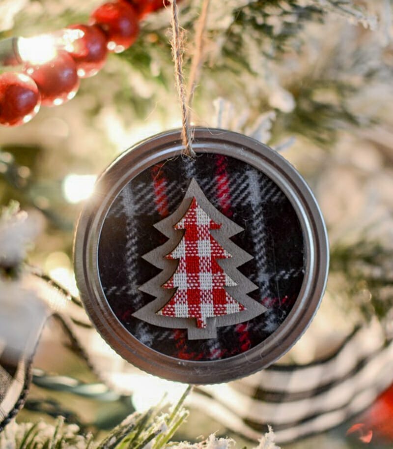 A fabric Christmas tree ornament made from a mason jar lid.