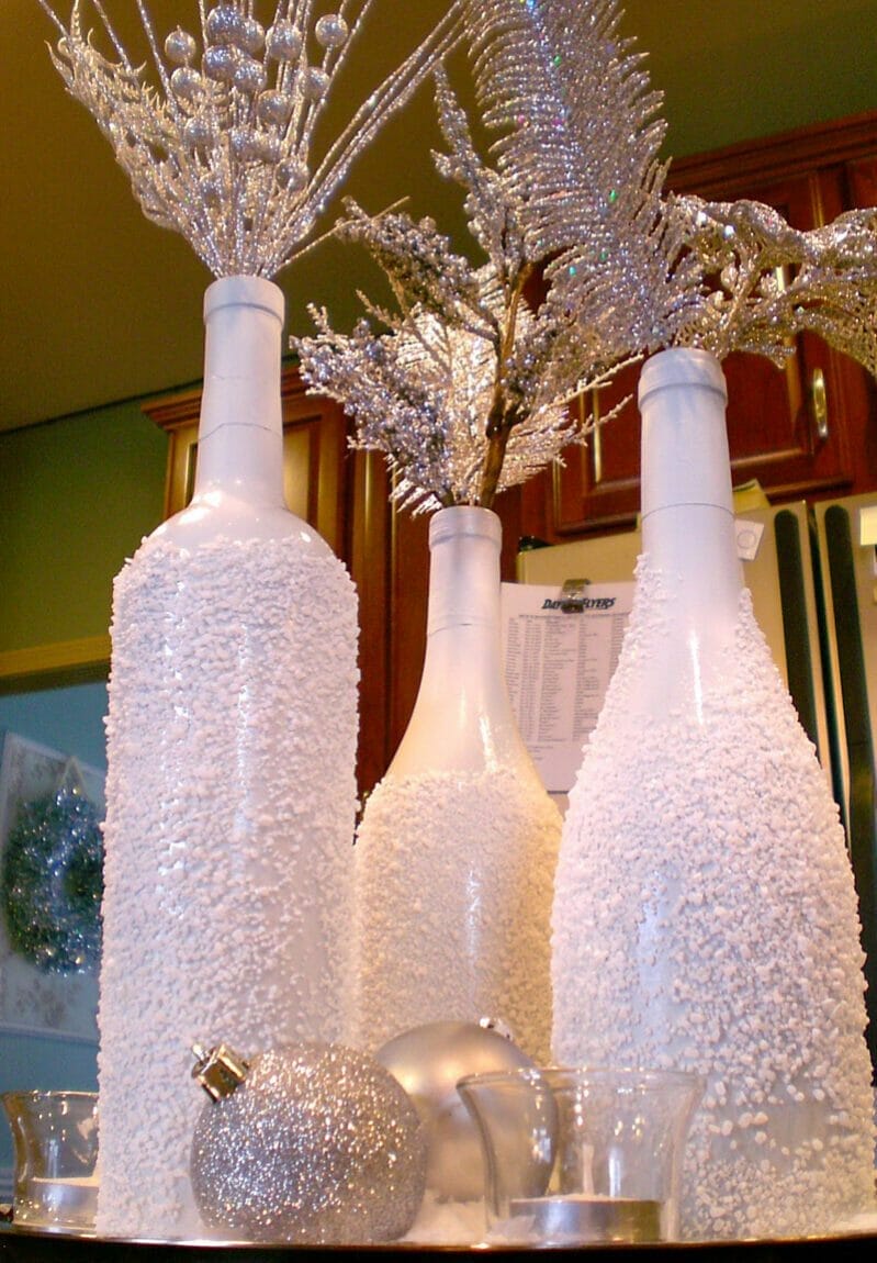 A snowy wine bottle centerpiece.