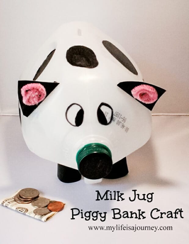 A black and white piggy bank made from a milk jug.