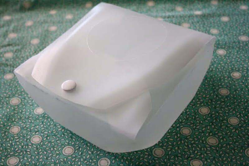 A reusable sandwich holder made from a cut up milk jug.