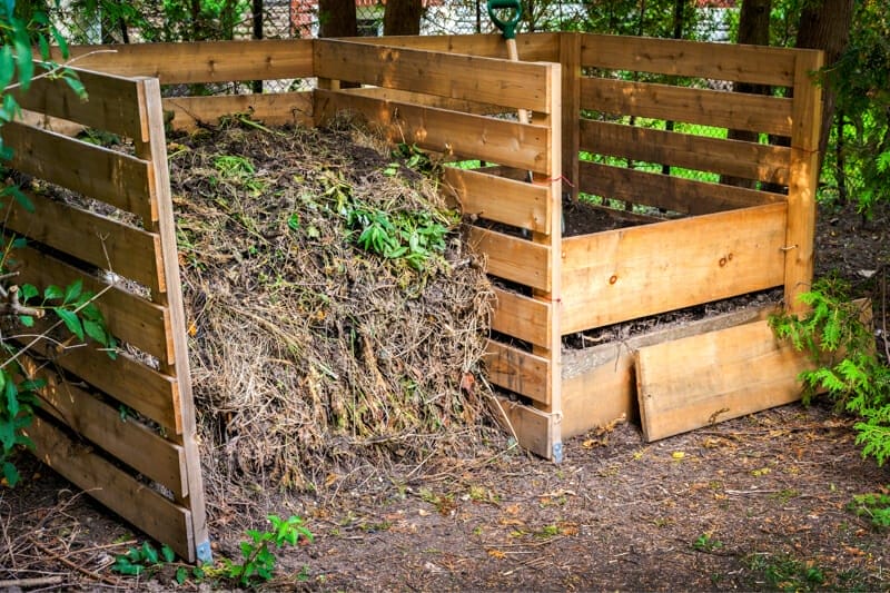 A compost bin filled with leaves, lawn clippings, food scraps, and urine.