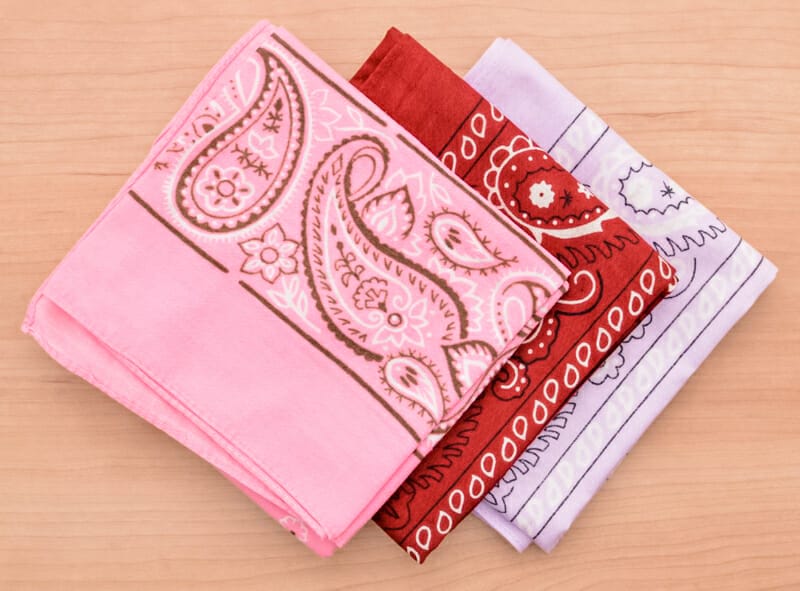 Folded pink, red, and purple bandanas.